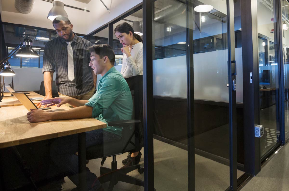 Image showing three people working on computer