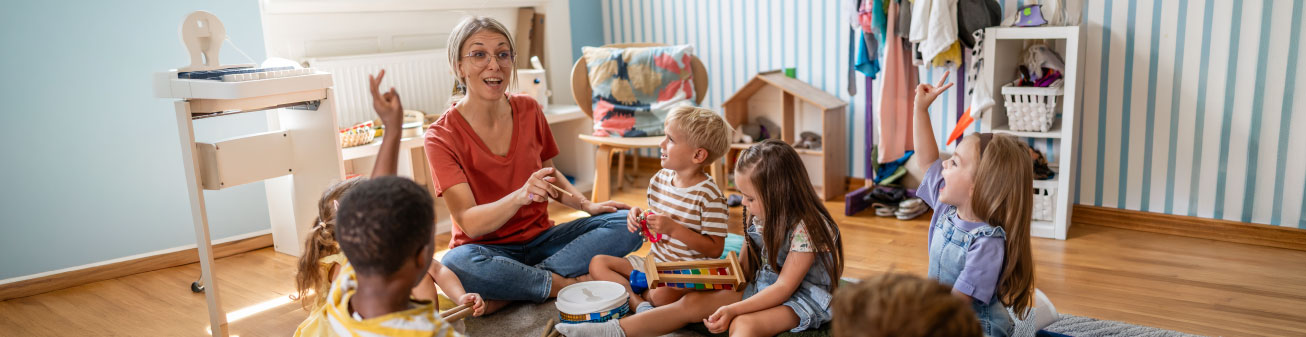 Teacher showing children how to use instruments