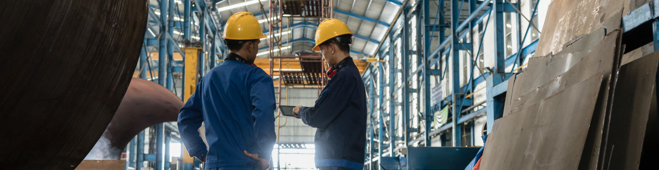 Two manufacturing employees discuss