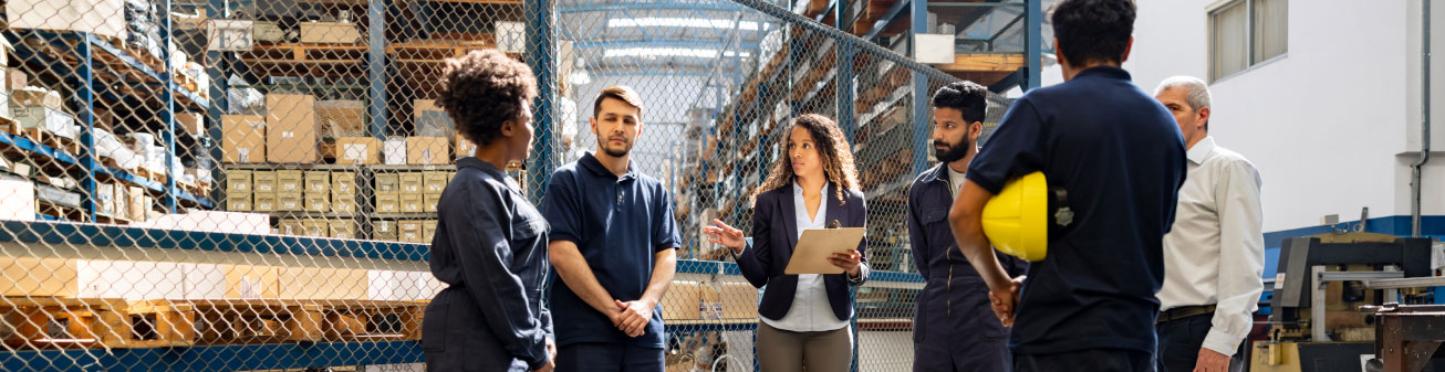 Employees in a meeting inside a warehouse