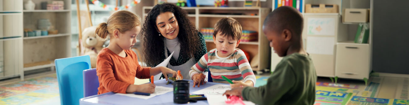 Teacher encouraging children while they color