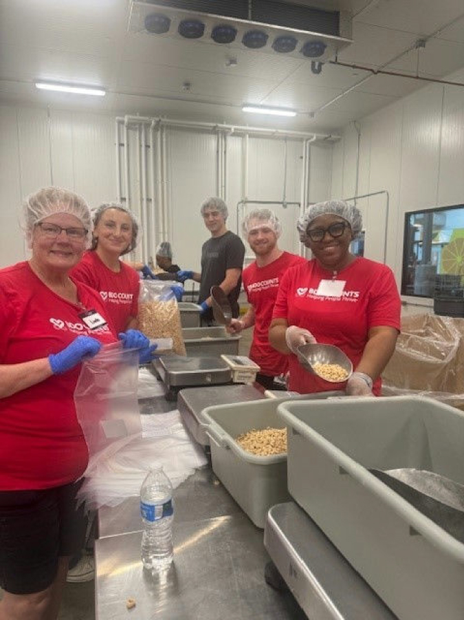 Baker (front left) and colleagues volunteer at a BDO Counts service event.