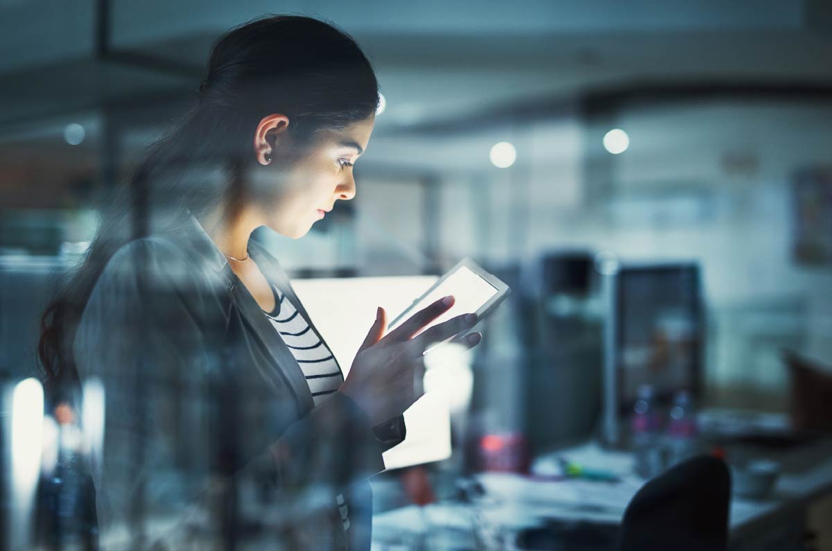 Woman viewing tablet, providing forensic accounting services