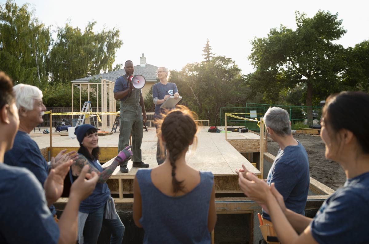 A person talking to a group of people at a construction site