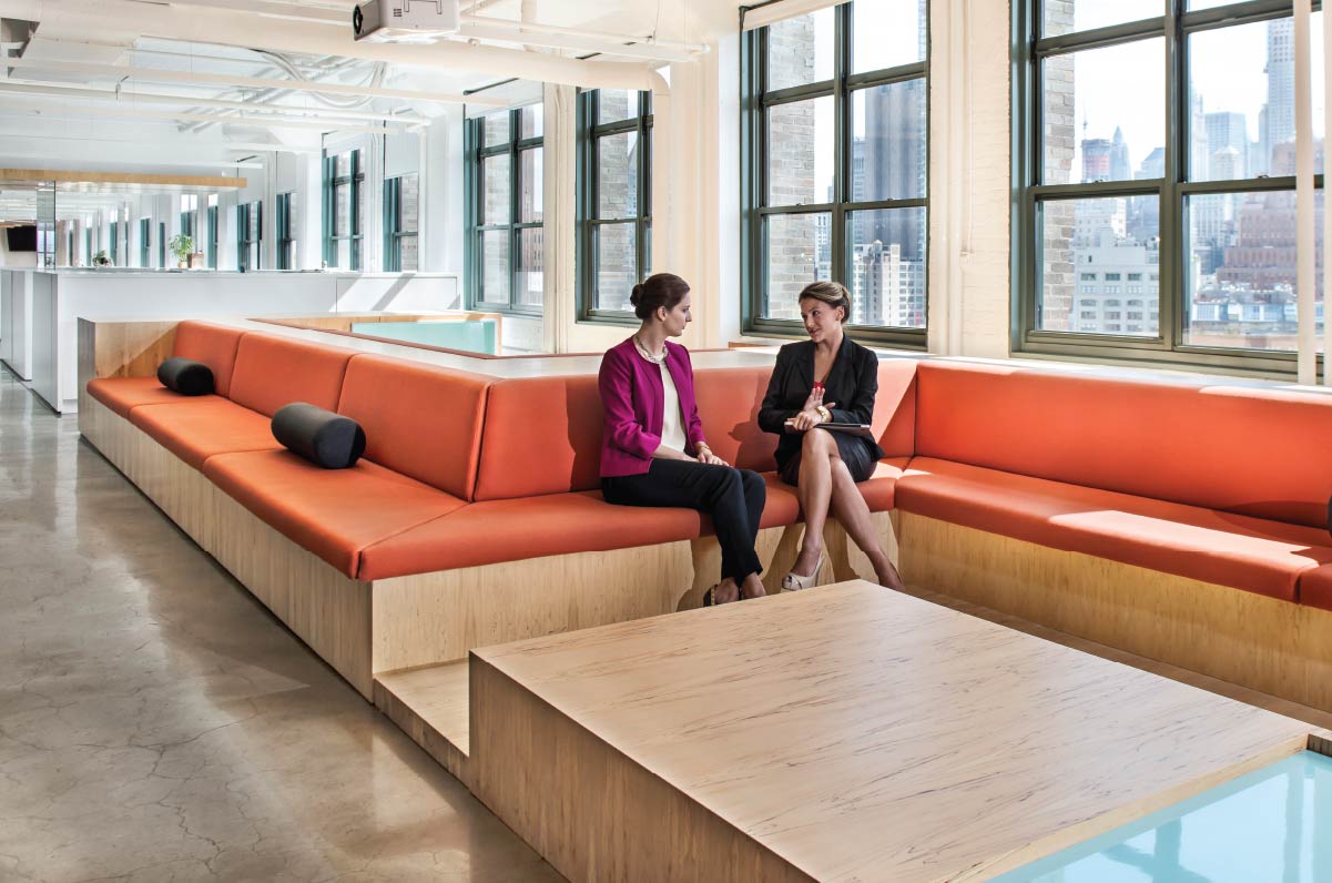 BDO Employees lounging on an office bench