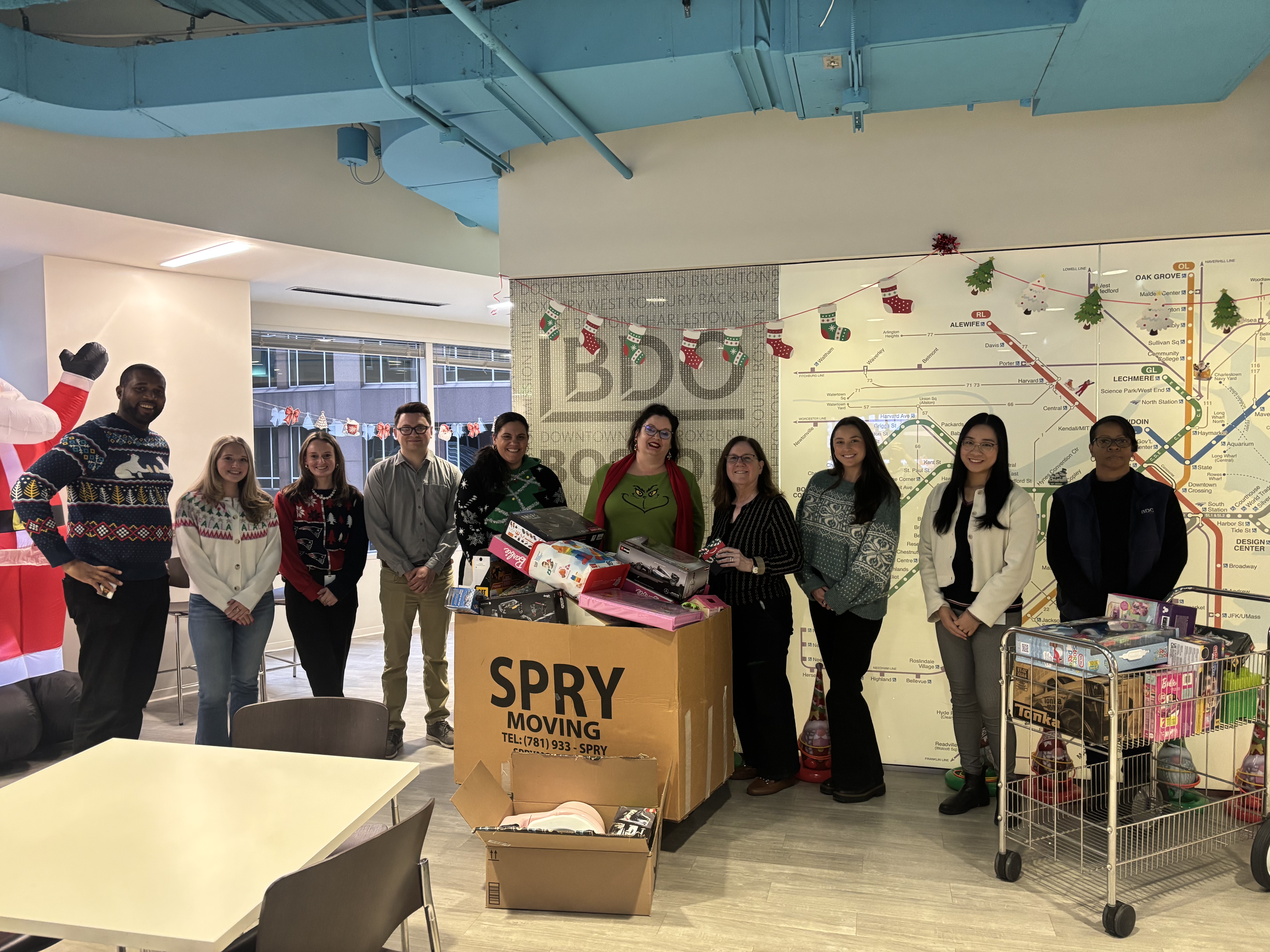 A photo of Turner volunteering with BDO Boston for a holiday drive.