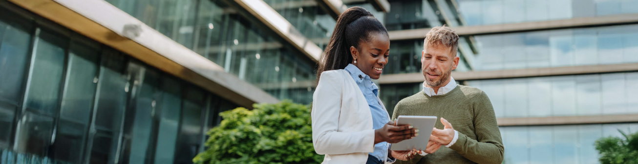 Image of people looking at a tablet. 