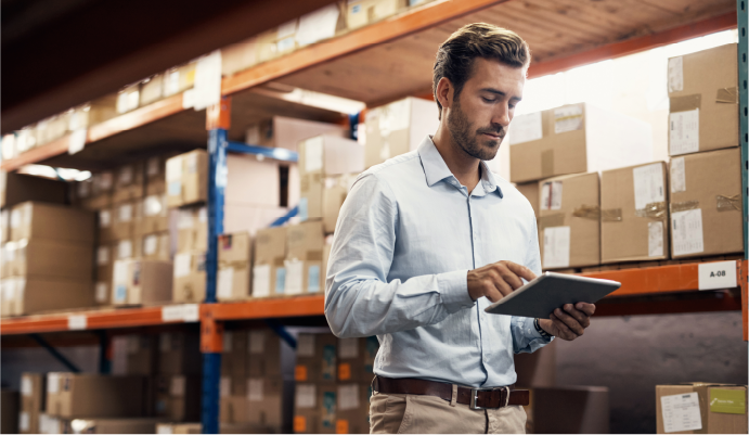 Employee using tablet in a warehouse