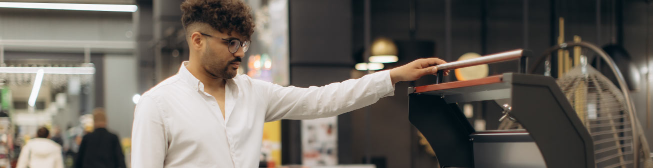 Person closing a grill cover.