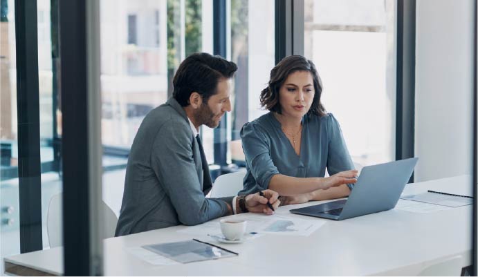 Two people working on a computer