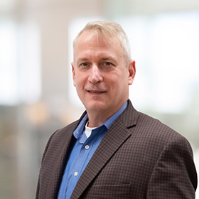 Professional headshot of Eric Derk