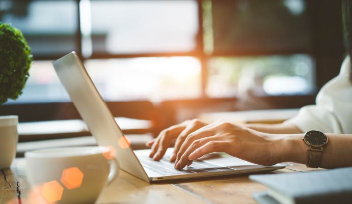 Person typing on a computer.