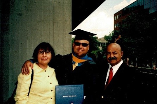 Jose with his parents on his graduation day